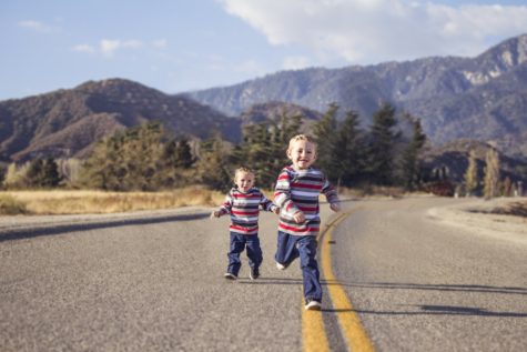Siblings running in street
