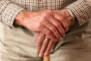 Senior citizen holding a walking stick