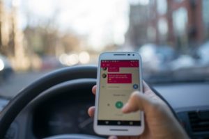 Distracted driver texting behind the wheel