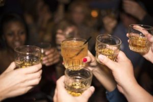 Group of people taking shots, drinking alcohol