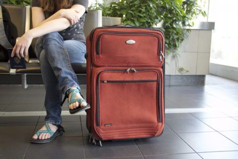 Person sitting at airport with luggage