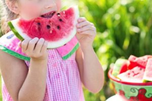 Little girl eating watermelon