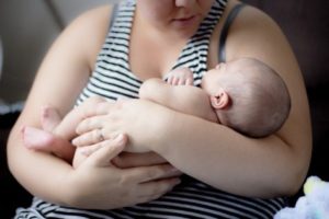 Mother holding new baby