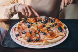 Person eating pizza dinner
