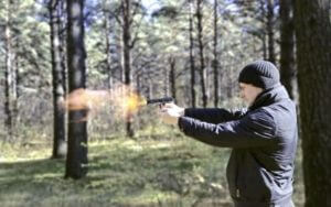 Man firing a gun