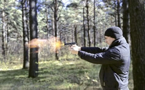 Man firing a gun