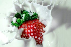 Strawberry splashing in milk