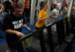 People running on treadmill at gym