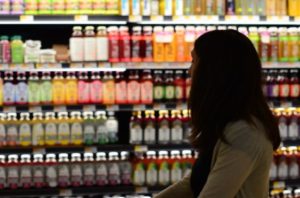 Woman food shopping at grocery store