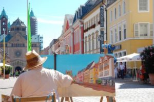 Artist painting row of homes