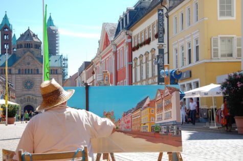 Artist painting row of homes