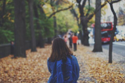 Child walking with backpack to school