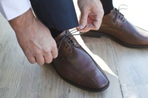 Man tying his dress shoes