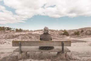 Person sitting alone on bench
