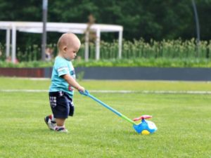 Toddler playing with toy at a park