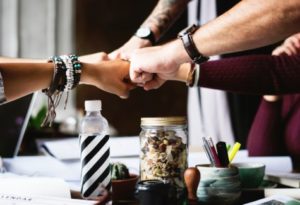 Group of people putting hands together