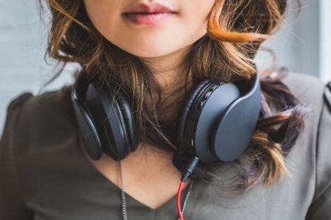 Woman with headphones around her neck