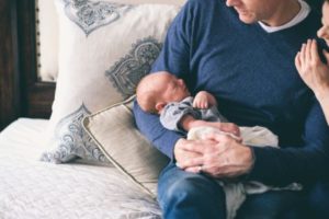 Father holding newborn baby