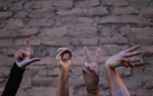 People using hands to make "Love" sign
