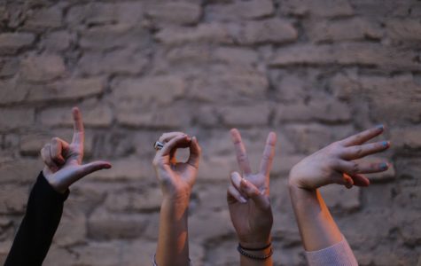 People using hands to make "Love" sign
