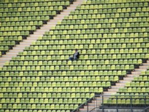 Person sitting alone in stadium