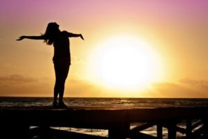 Happy woman soaking in the sunset