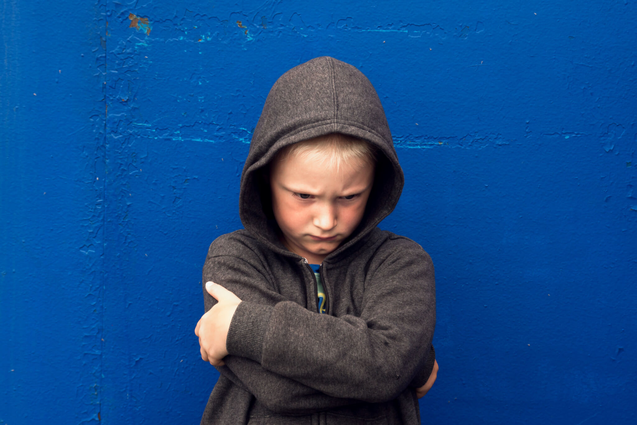 Angry, upset boy alone, antisocial