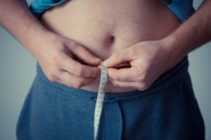 Person measuring waist, weight
