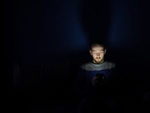 Person using phone in bed