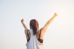 Woman with arms in air