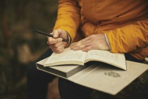 Person writing in notebook