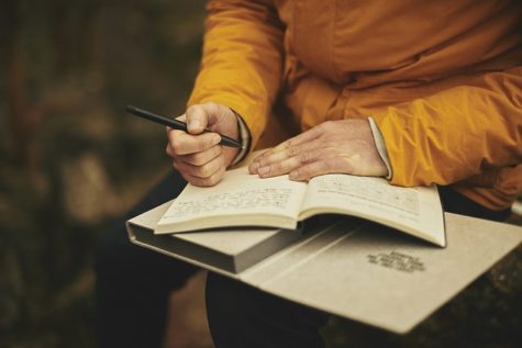 Person writing in notebook