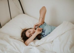 College student sleeping in bed