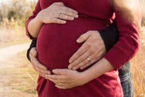 Man holding pregnant woman