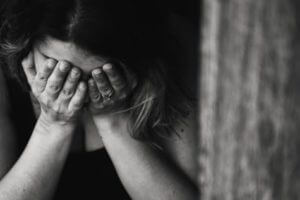 Sad woman with face in hands