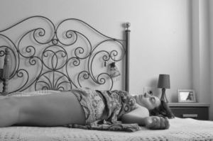 Woman lying on bed