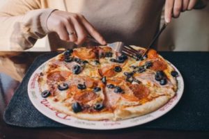 Person eating pizza