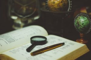 Science - magnifying glass on book