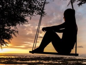 Sad girl on swing