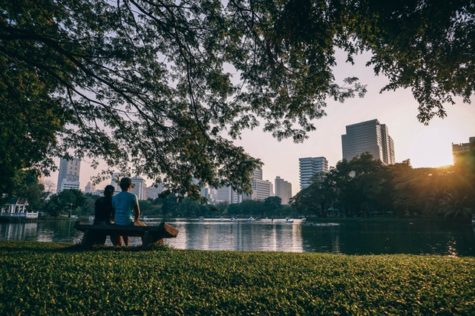 People sitting on a park bench in the city