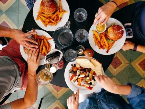 People eating burgers at restaurant