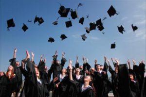 Graduates throwing their mortarboards