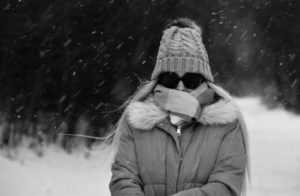 Cold woman bundled up in the snow