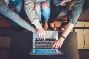 Group of people looking at computer