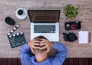 Person at desk feeling stressed