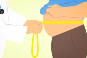 Doctor measuring patient's waist