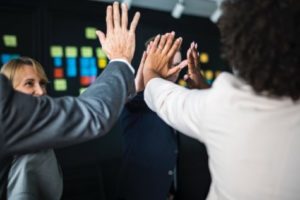 Group of office workers high-fiving