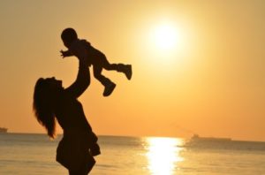 Mother with child at sunset
