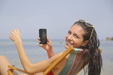 Woman using phone at beach