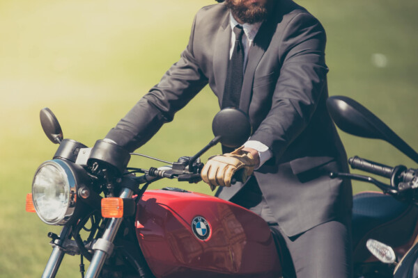 Man in suit riding BMW motorcycle